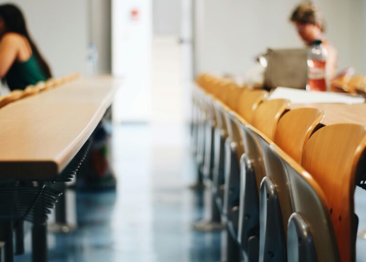 Bright classroom scene with wooden chairs, ideal for educational themes.