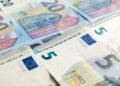 Detailed view of 5 and 20 euro banknotes showcasing European currency design.