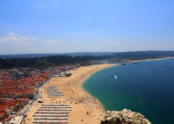 a beach with many buildings and water