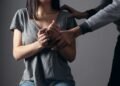 woman in gray scoop neck shirt holding her hands