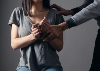 woman in gray scoop neck shirt holding her hands