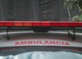 A close-up view of a city ambulance with a red siren light and Portuguese text 'AMBULÂNCIA'