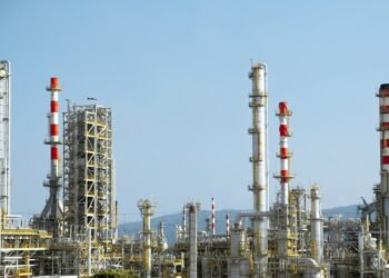 A factory with a lot of red and white pipes