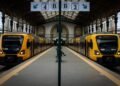 Symmetrical view of two trains at São Bento Station in Porto, Portugal.