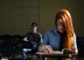 Two students study in a dimly lit classroom in Buenos Aires, Argentina.