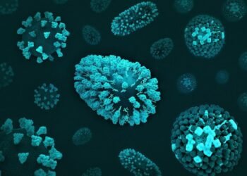 a group of blue and green cells on a black surface