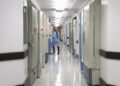 man in blue dress shirt walking on hallway