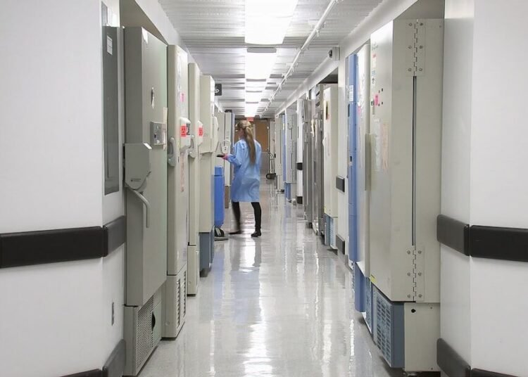 man in blue dress shirt walking on hallway