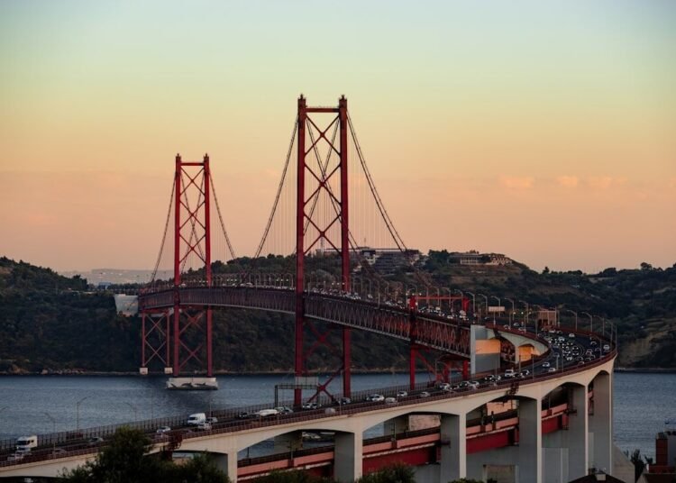 red bridge over the river during daytime