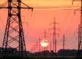 silhouette of electric post during sunset