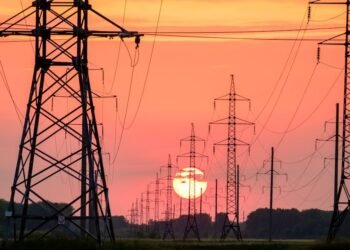 silhouette of electric post during sunset