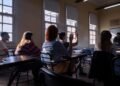 Students attentively listening and participating in a classroom discussion.
